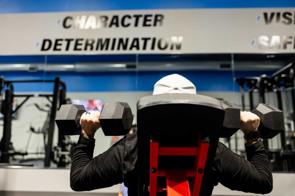 Photo of electrical employee lifting weights in the office gym