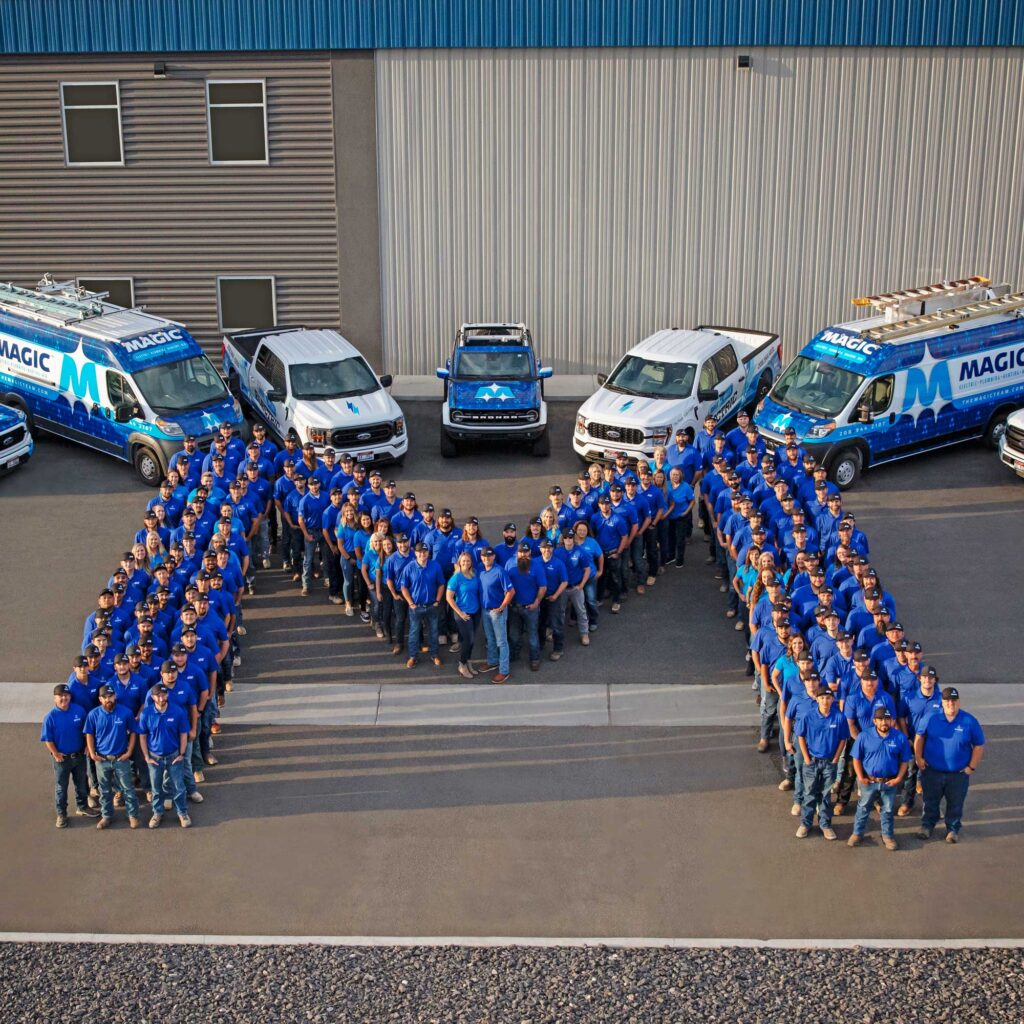 Photo of Magic Valley Electric employees gathered in the shape of an "M"